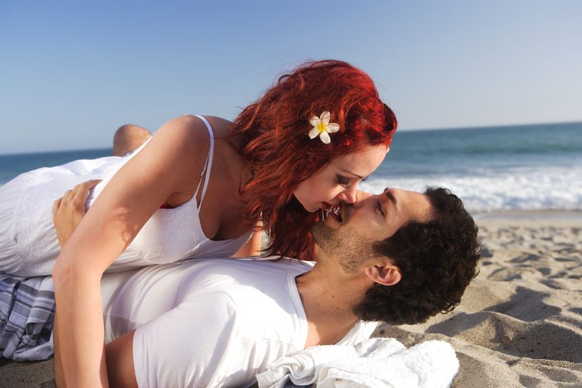 Love on the beach in the sand kissing